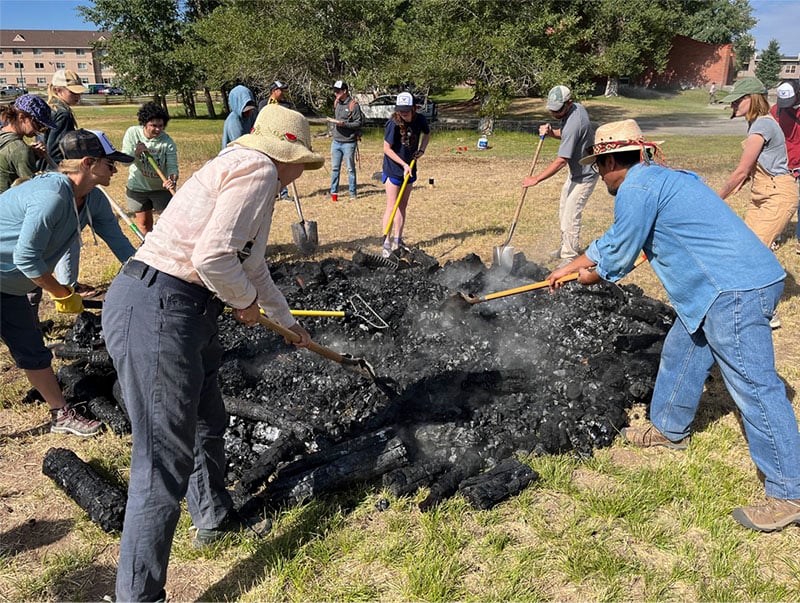 A team works on creating biochar.