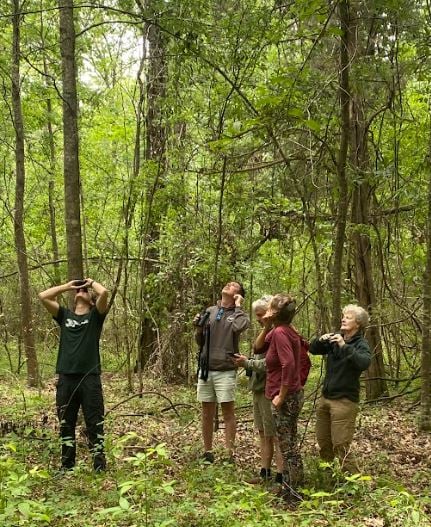 Western graduate students look for birds with binoculars.
