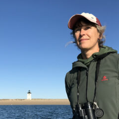 Elizabeth Bradfield poses in front of a lighthouse.