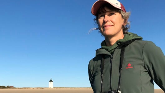 Elizabeth Bradfield poses in front of a lighthouse.