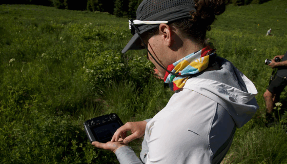 A student operates a control in the field.