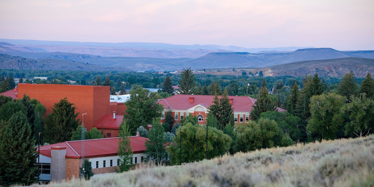 Taylor Hall and Hurst Hall at sunrise with mountains in the background.