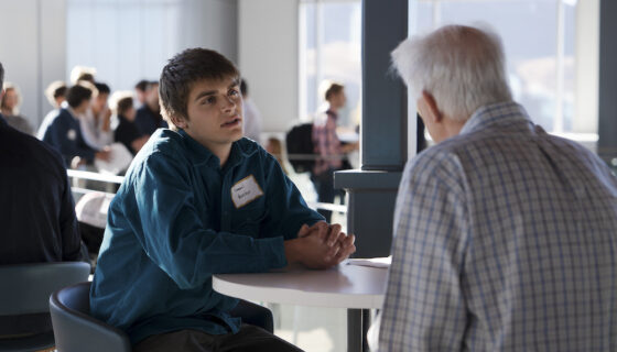A student talks with an employer during a speed networking session for the Rady Career Fair.