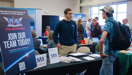 A student talks with an employer during a career and internship fair.