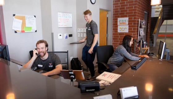 A photo of a few of the Mountaineer Field House staff at the front desk.