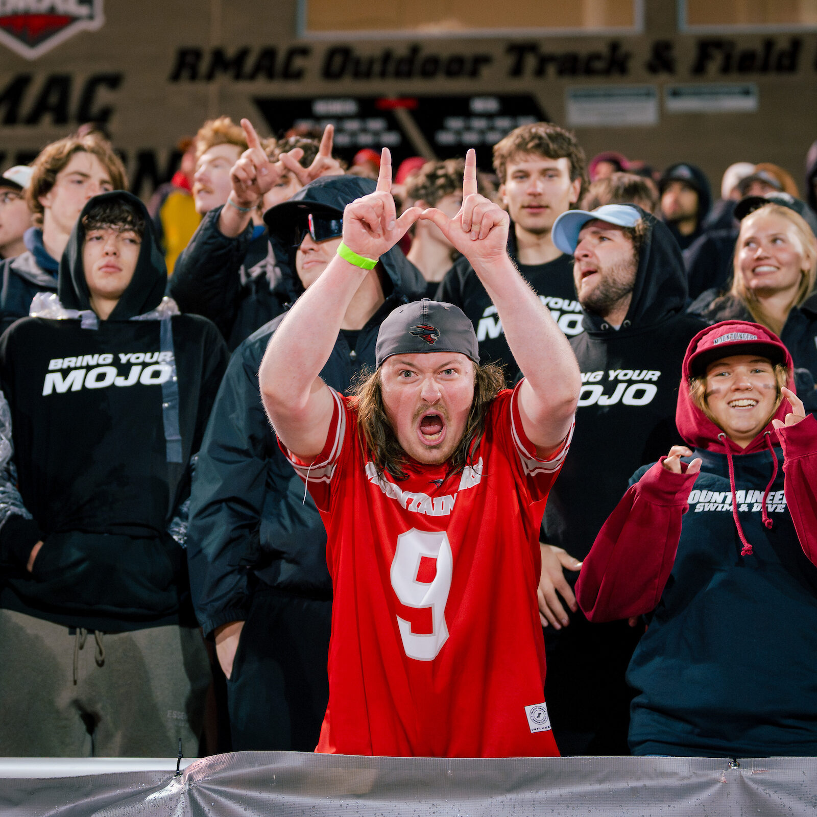 Western cheerleader faces the student section during the family weekend football game.