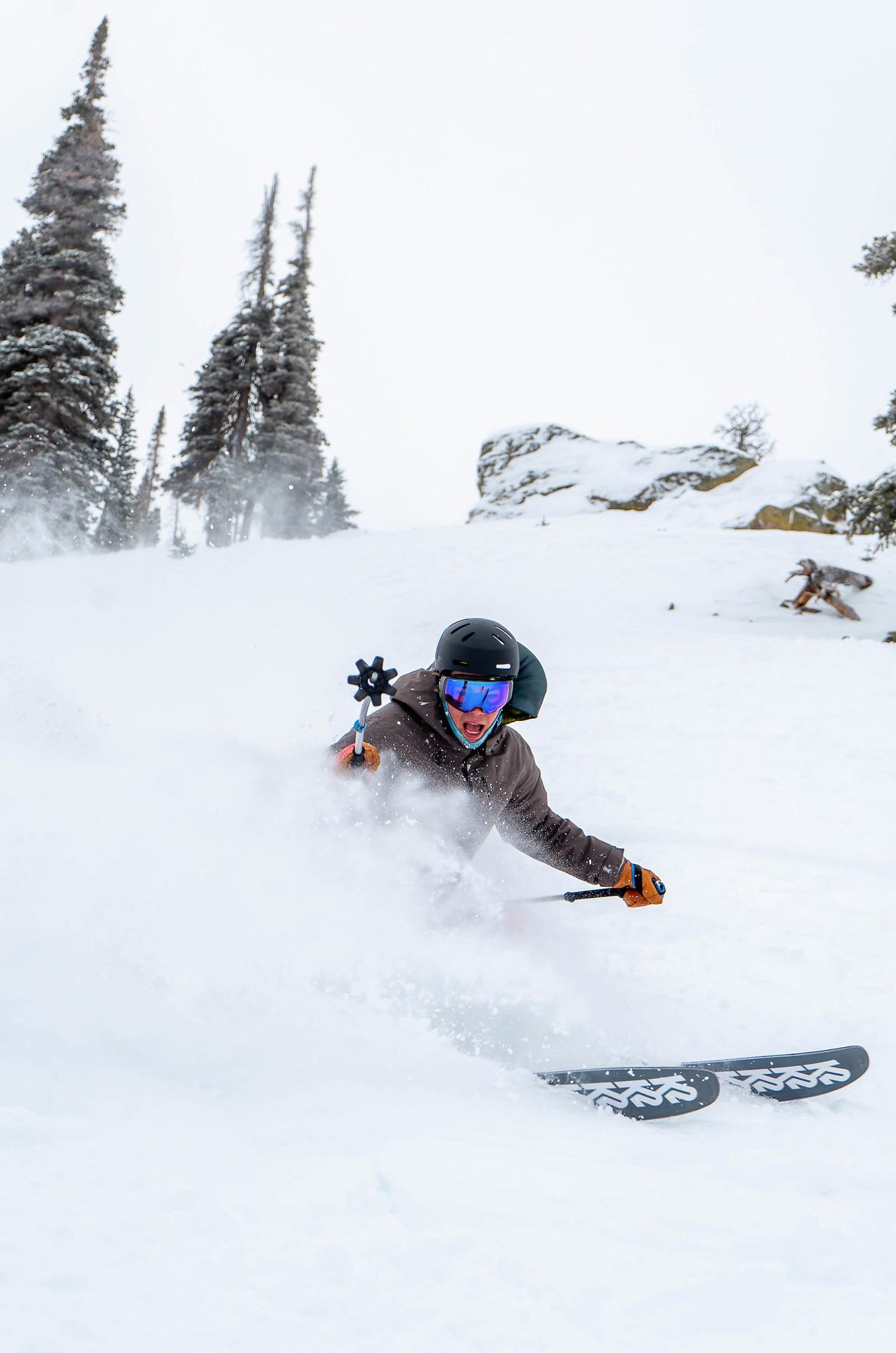 A student slashes through powder while skiing at Crested Butte.