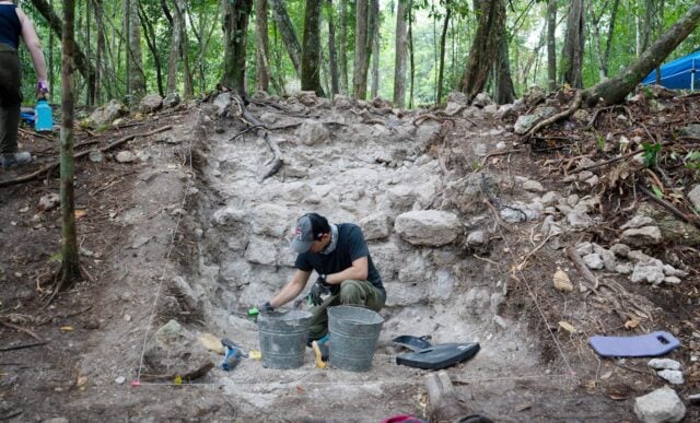 A student works on an excavation of a Maya building during the Maya Archaeological Field School in Belize.