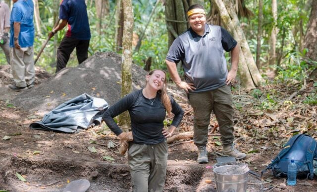 Two students take a pause from working and smile for a photo during the Maya Archaeological Field School in Belize.