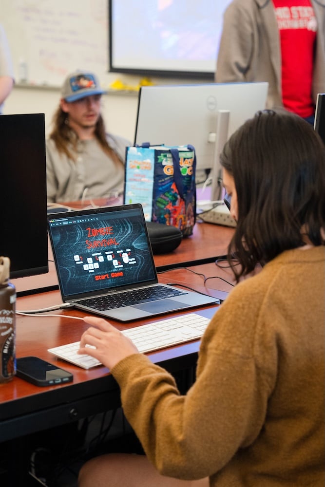 A Western student playing "Zombie Survival" on a laptop in the computer science room.