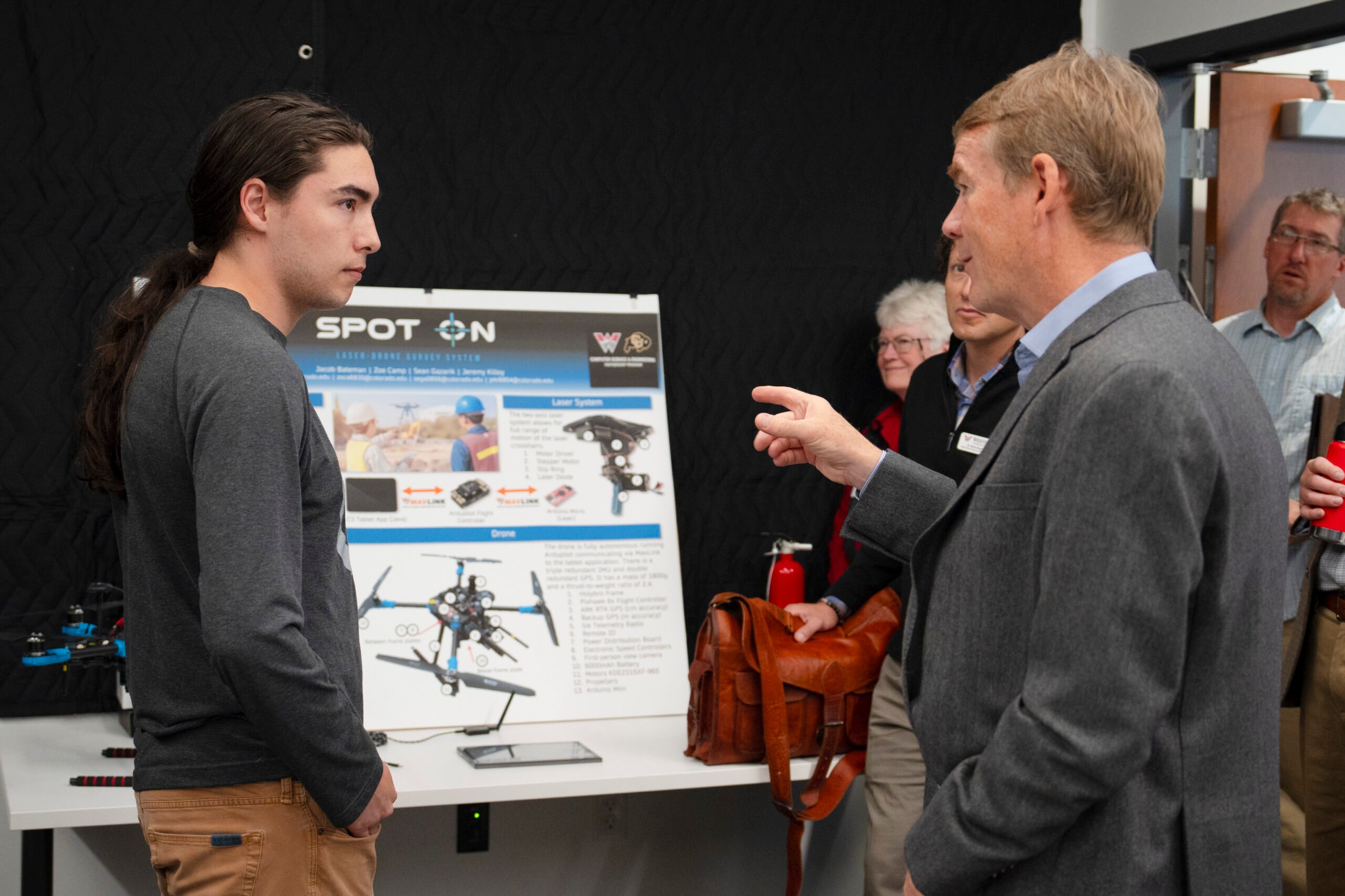 Former Western student, Jayden Omi gives Senator Bennet an overview of the drone flying program in the Rady School of Engineering.