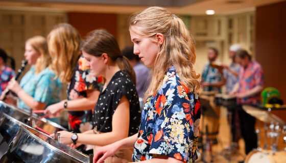 A student plays a steel pan during a steel band practice in the Kincaid Concert Hall.