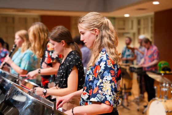 A student plays a steel pan during a steel band practice in the Kincaid Concert Hall.