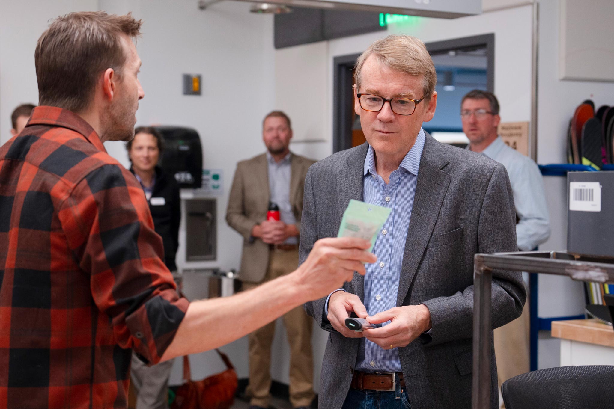 Dr. Greg VanderBeek shows Senator Michael Bennet some products from an industry partner, Pact Outdoors, during a tour of the Rady School of Engineering at Western Colorado University.