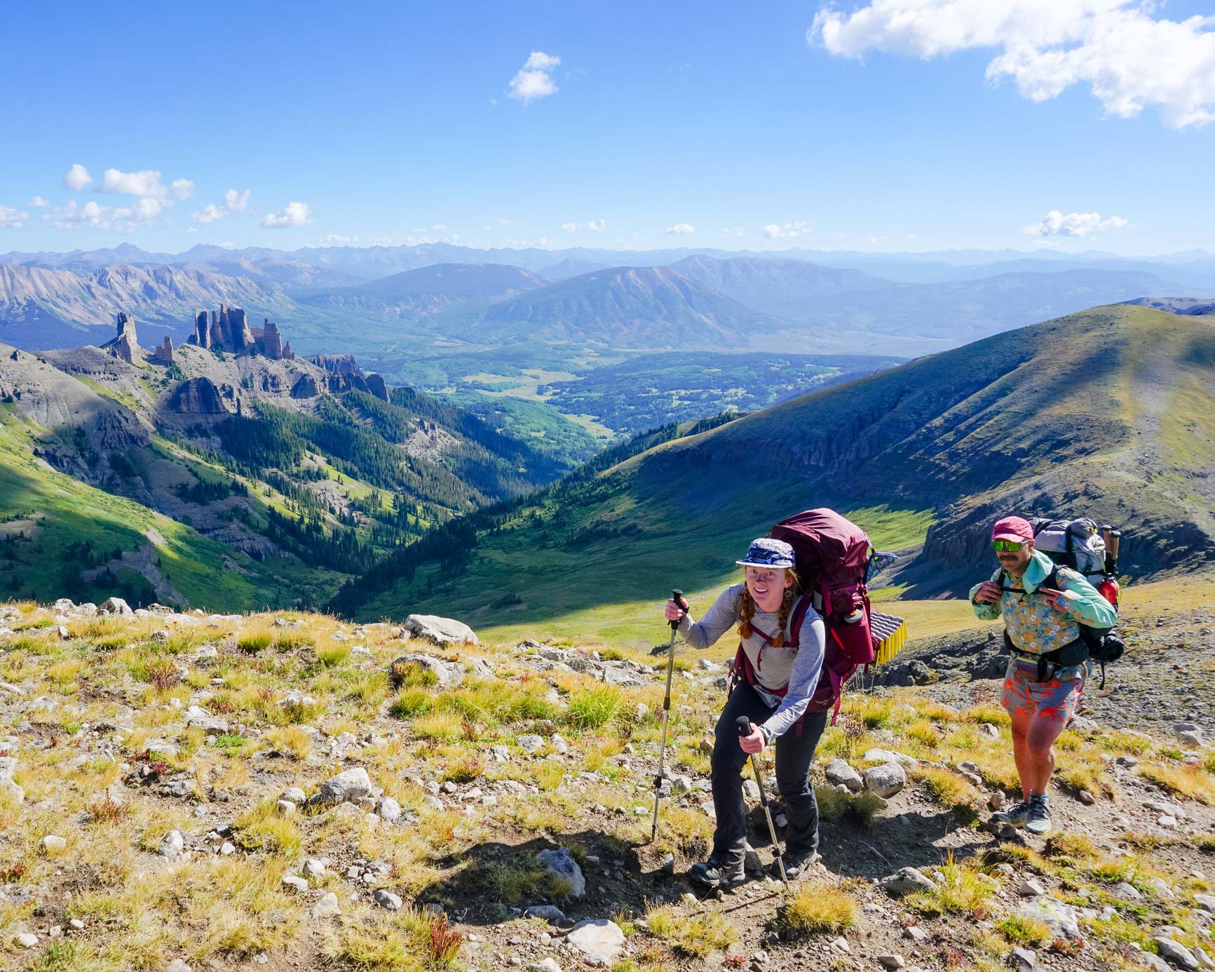 Two students smile at the top of Storm Pass while on a backpacking trip.