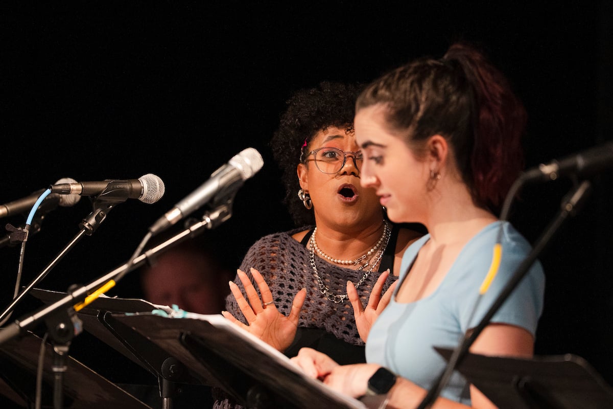An actress looks at her scene partner and delivers a line during Steven Cole Hughes's 'Singletrack! The Musical'.