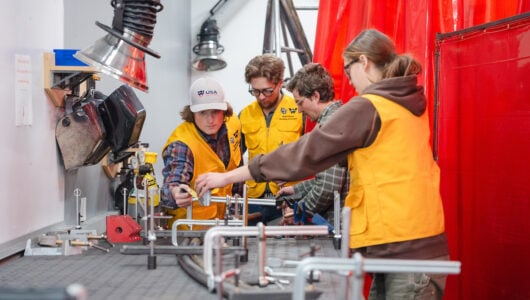 Mechanical Engineering students create a rail with their professor for Rail Jam in the Maker Space in the Rady Building.
