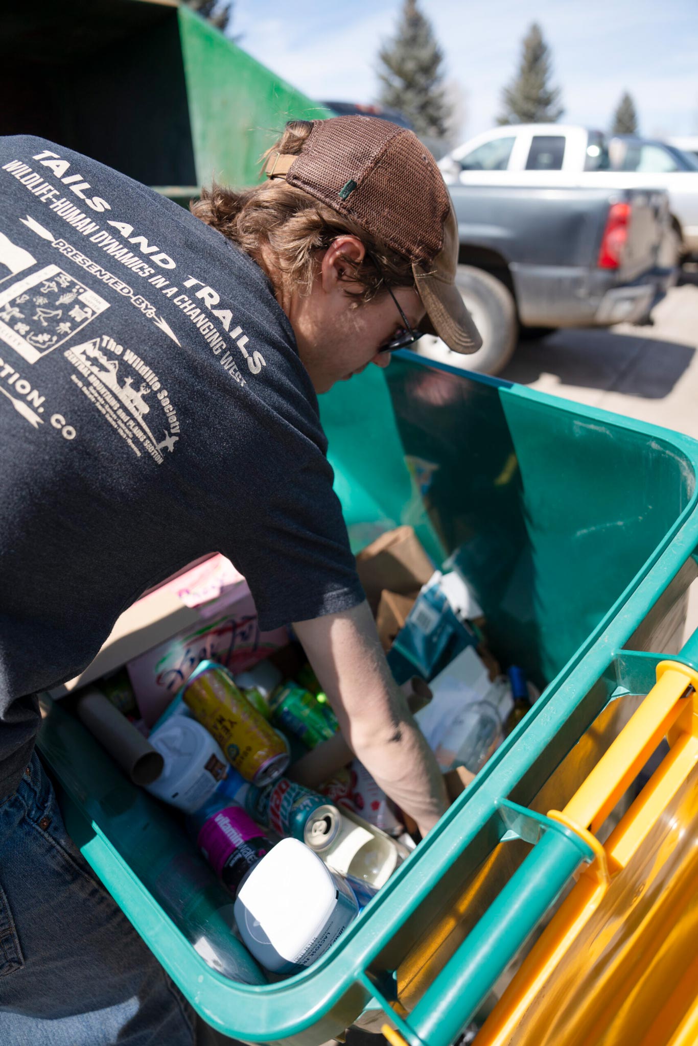 Student Erik Rathmann sorts through a recycling bin and to pull out any trash that doesn't belong there.