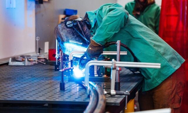Mechanical Engineering students weld a rail for Rail Jam in the Maker Space in the Rady Building.