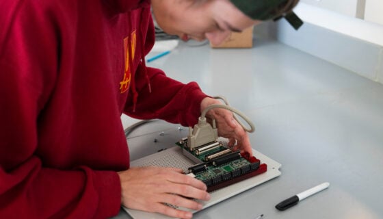A student assembles a circuit board for the sensor suite engineering students are building for Rocky Mountain Biological Lab.