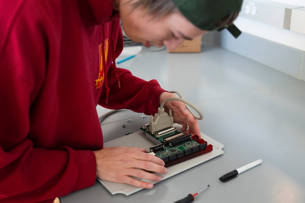 A student assembles a circuit board for the sensor suite engineering students are building for Rocky Mountain Biological Lab.