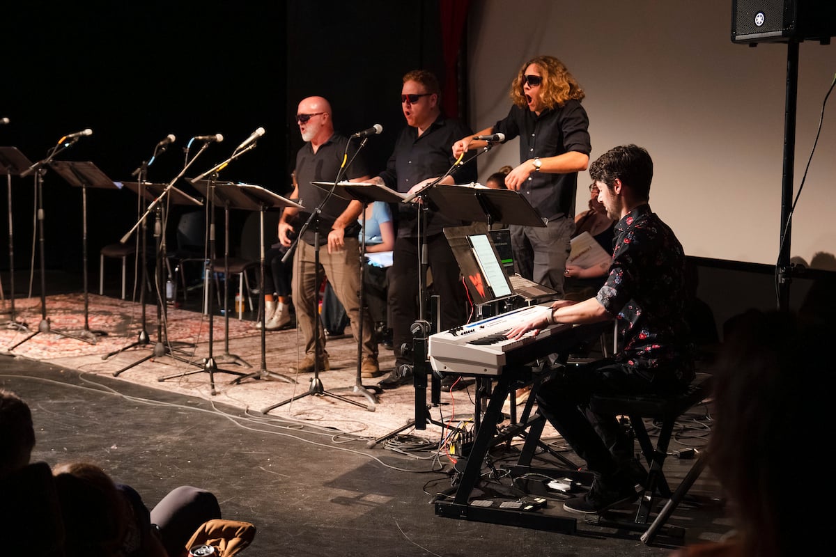 Three actors wear sunglasses and sing a song where the only lyric is "Bro" during a scene in Steven Cole Hughes's 'Singletrack! The Musical'.
