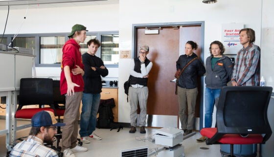 Engineering students show their partially assembled sensor suite to people from the Rocky Mountain Biological Lab for feedback.