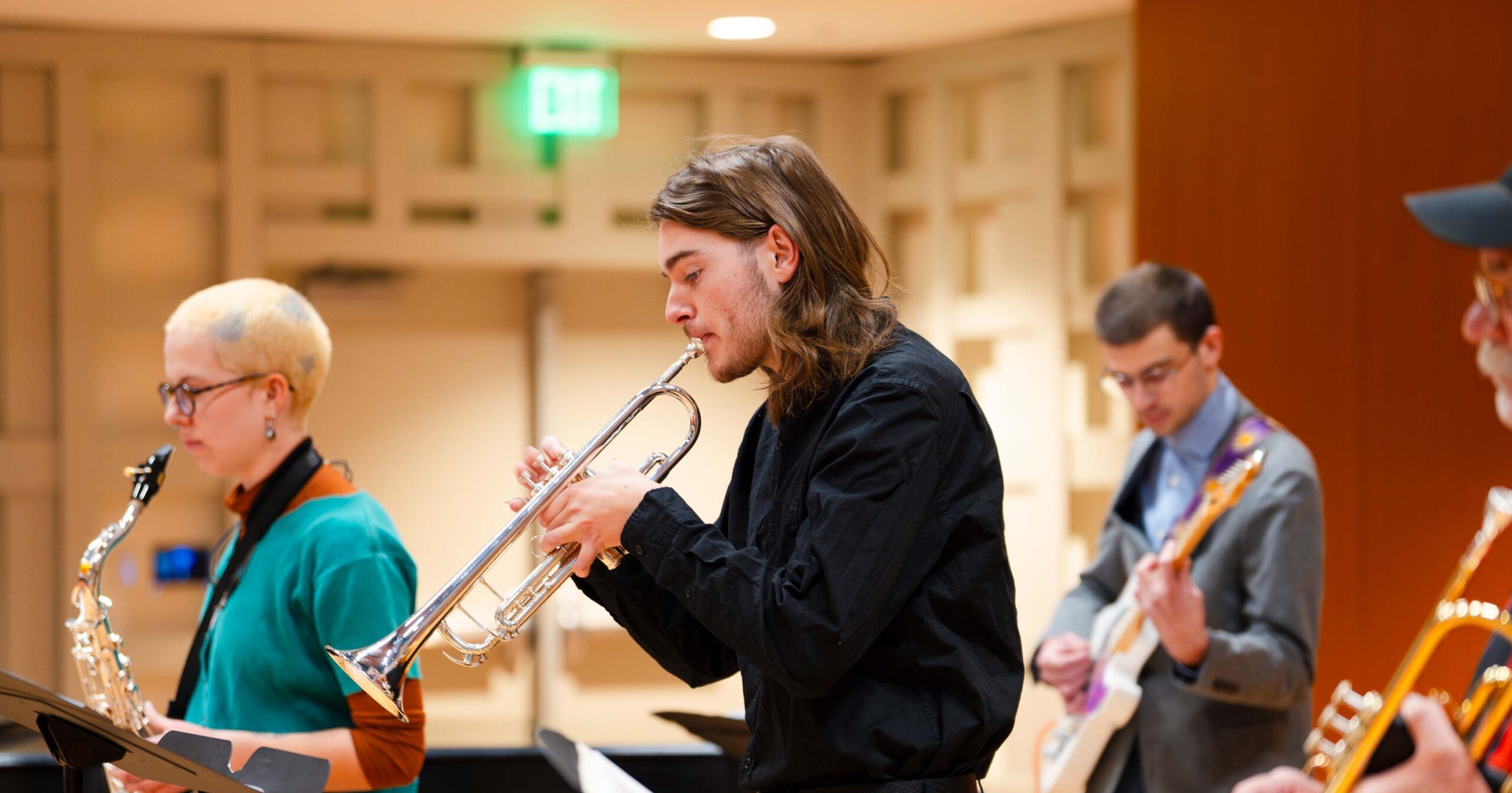 A student plays the trumpet during practice with the jazz band in Kincaid Concert Hall.