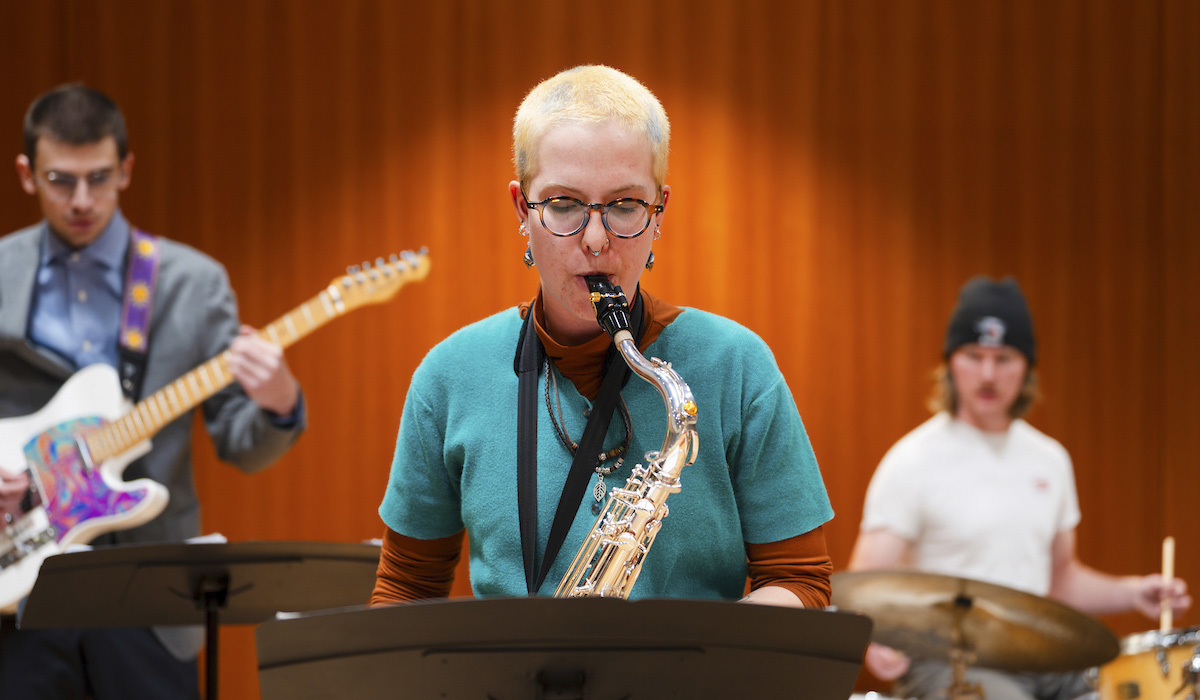 A student plays the saxophone during practice with the jazz band in Kincaid Concert Hall.