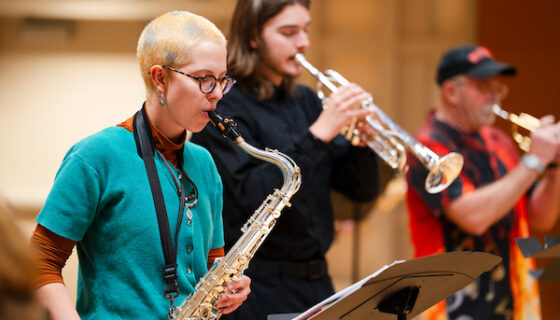 A student plays the saxaphone during practice with the jazz band in Kincaid Concert Hall.