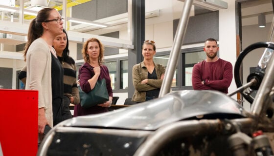 Jeni Blacklock shows visitors from Colorado's OEDIT a Baja that was built by the SAE (Society of Automotive Engineers) club.