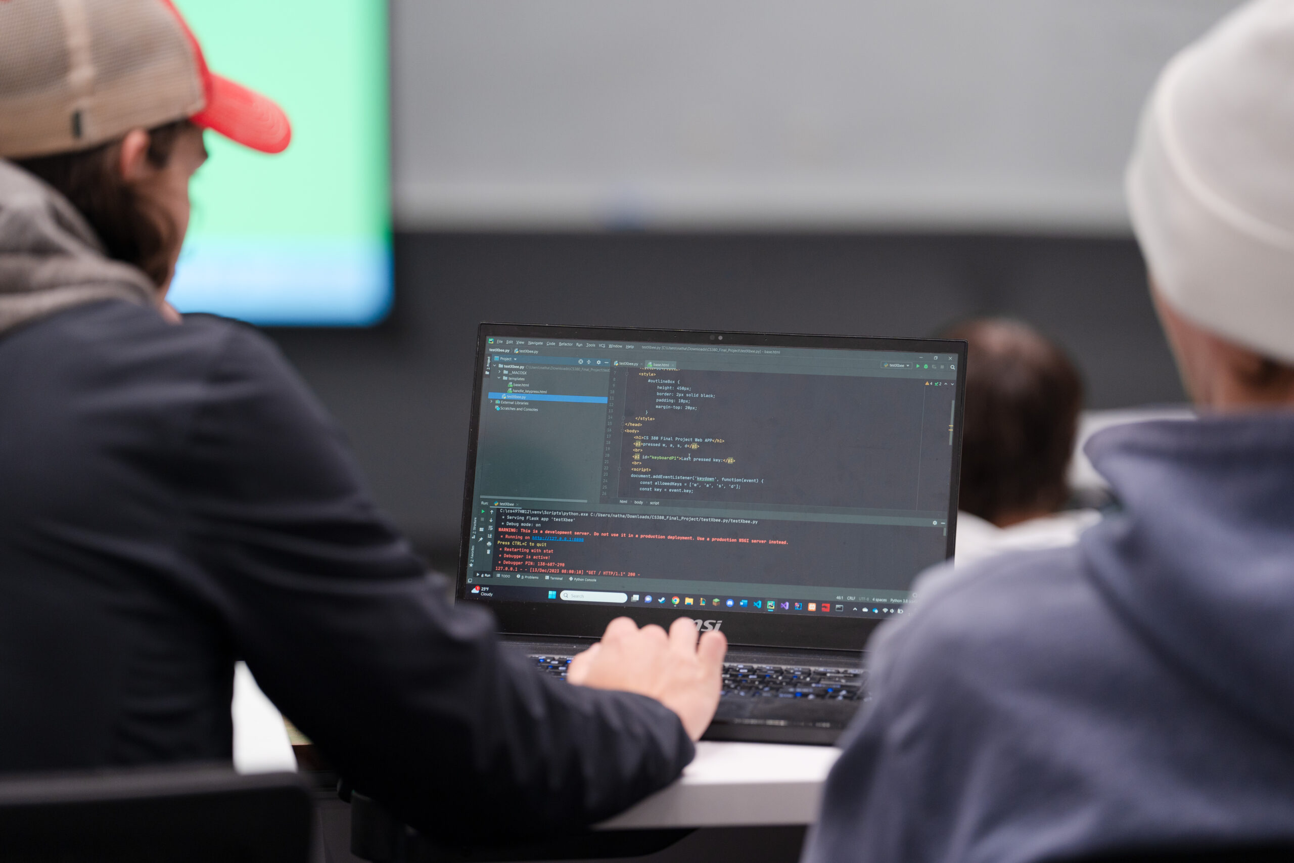 A student works on some code on his laptop during a computer science class.
