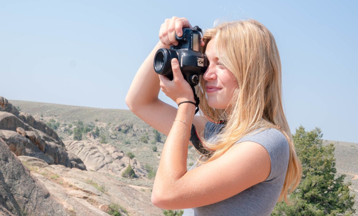 Mary Donohue takes photographs of Hartman rocks.