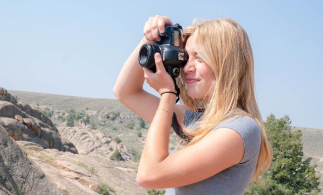 Mary Donohue takes photographs of Hartman rocks.