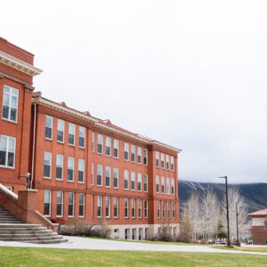 Photo of Taylor Hall and W Mountain from Taylor Lawn on a misty spring afternoon.