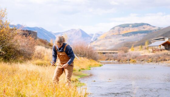 A volunteer collects willow reeds along the streambank of the Slate River on Verzuh Ranch.