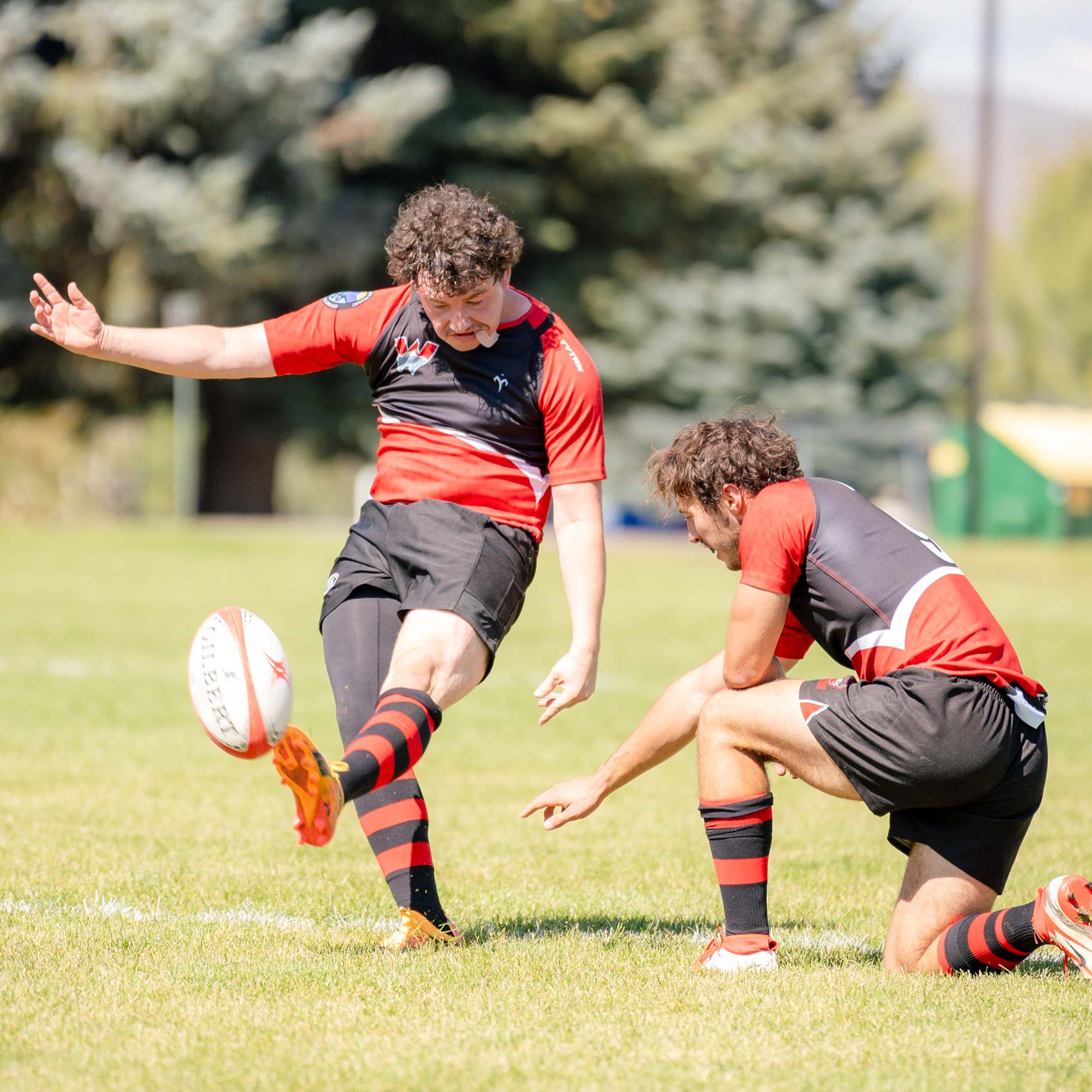 Western player kicks the ball after a try point