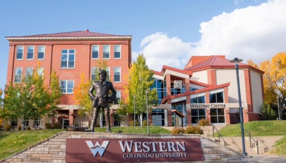 A photo the mountaineer statue with Taylor Hall in the background during the fall.