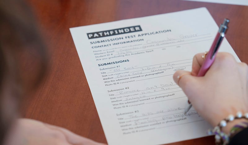 An art student fills out a Pathfinder Magazine submission application during the Submission Festival.