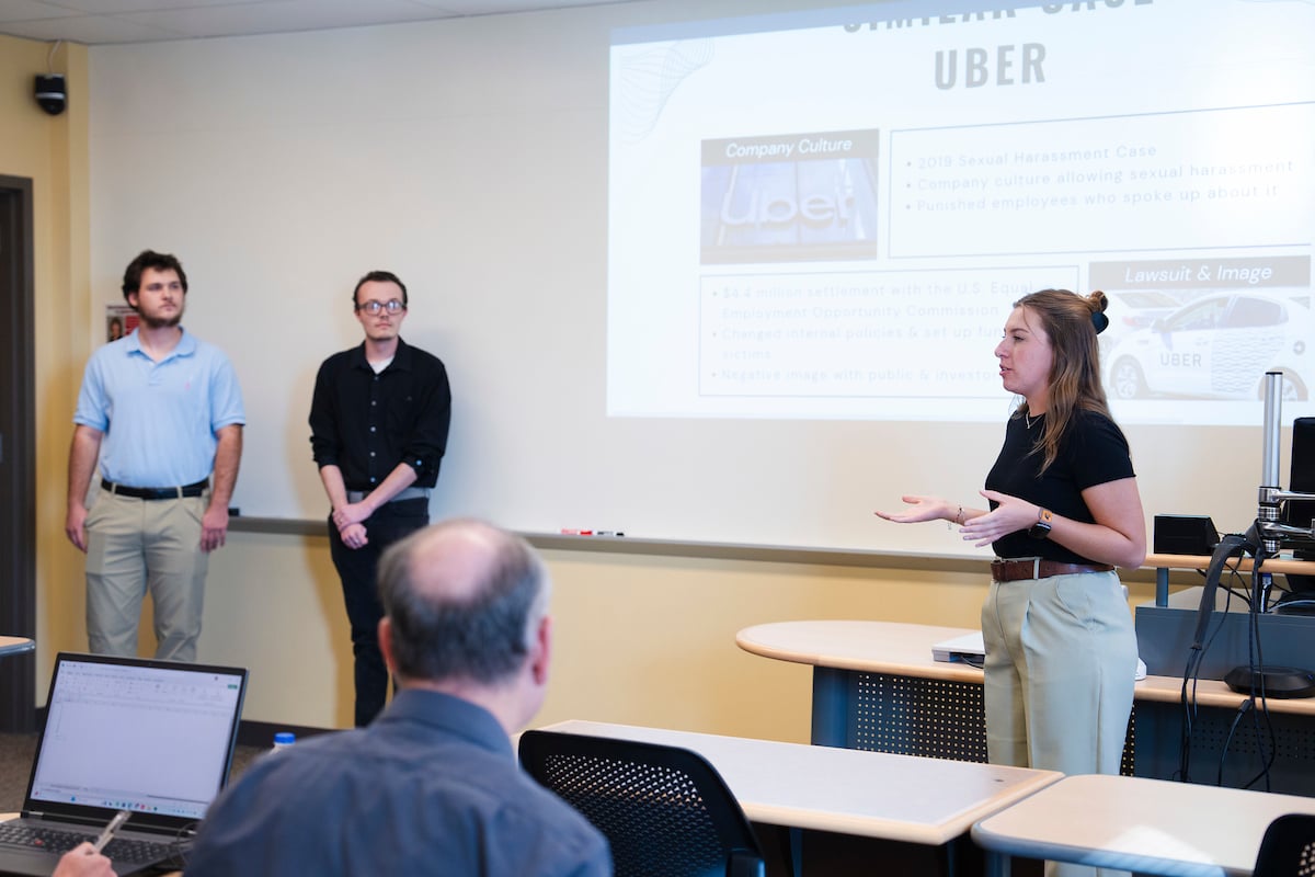 A Western student gives her part of her group's presentation for the School of Business ethics competition.