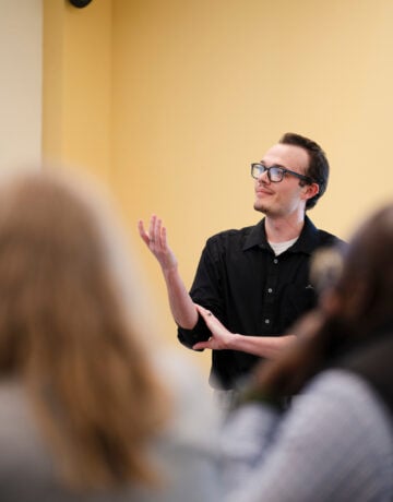 A student speaks during his group's presentation for the School of Business ethics competition.