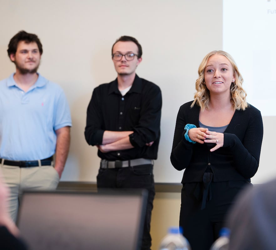 A student speaks during her group's presentation for the School of Business ethics competition.