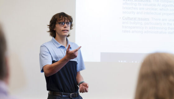 A student speaks during his group's presentation for the School of Business ethics competition.