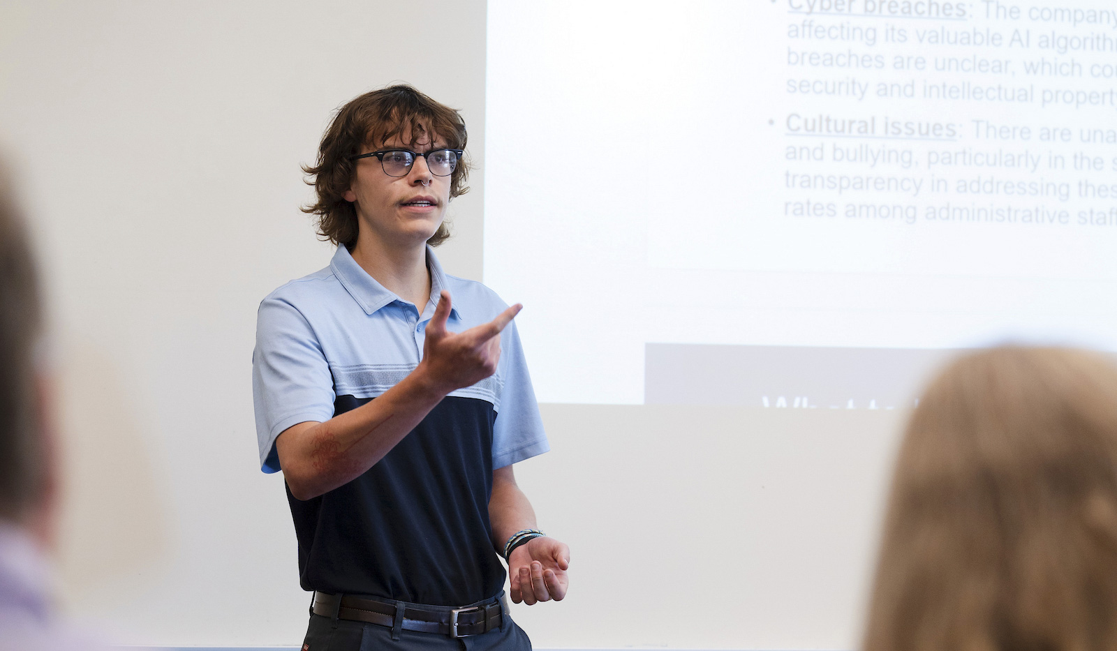 A student speaks during his group's presentation for the School of Business ethics competition.