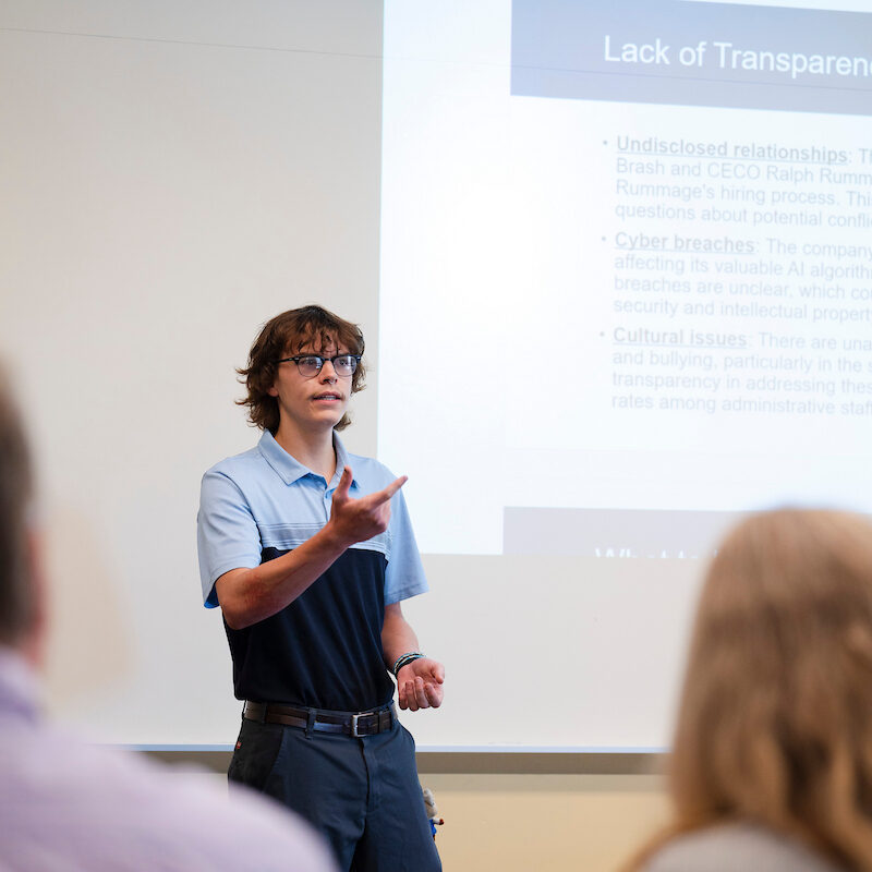 A student speaks during his group's presentation for the School of Business ethics competition.