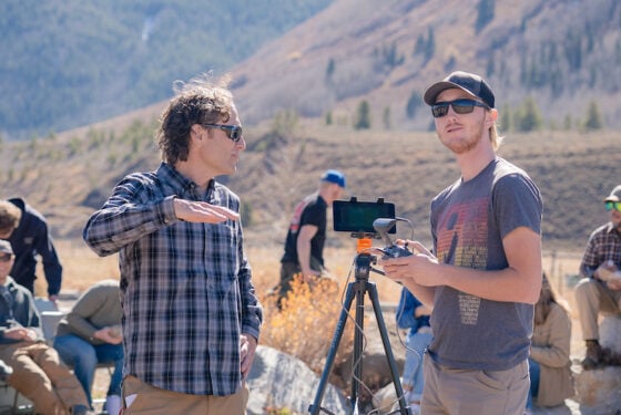 Professor Micah Russell show a student how to fly the drone