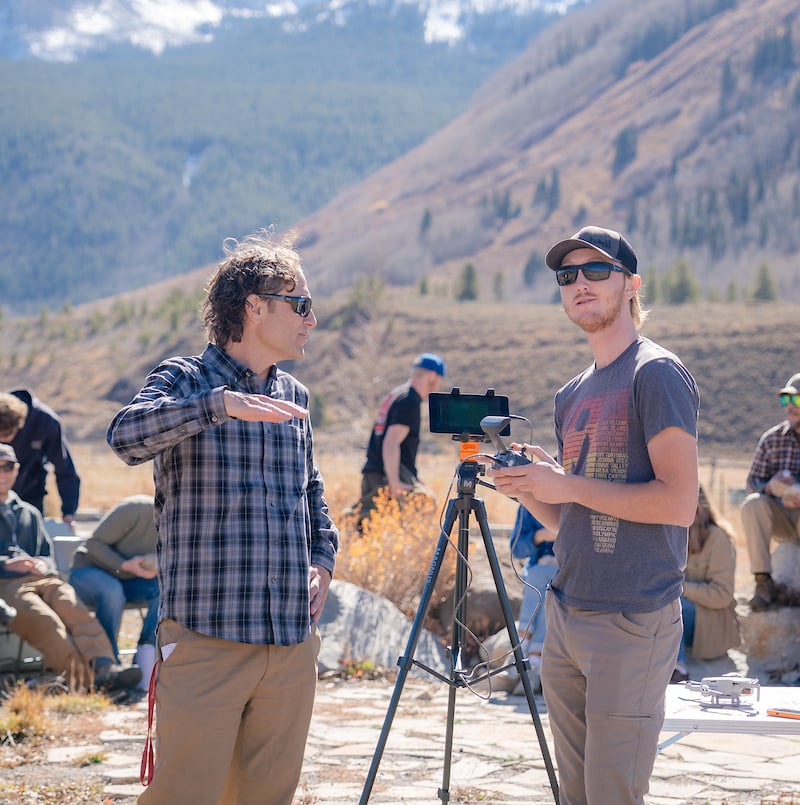 Professor Micah Russell show a student how to fly the drone