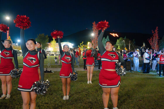 The Cheer Team and WCU band performs with the W on fire in the background.