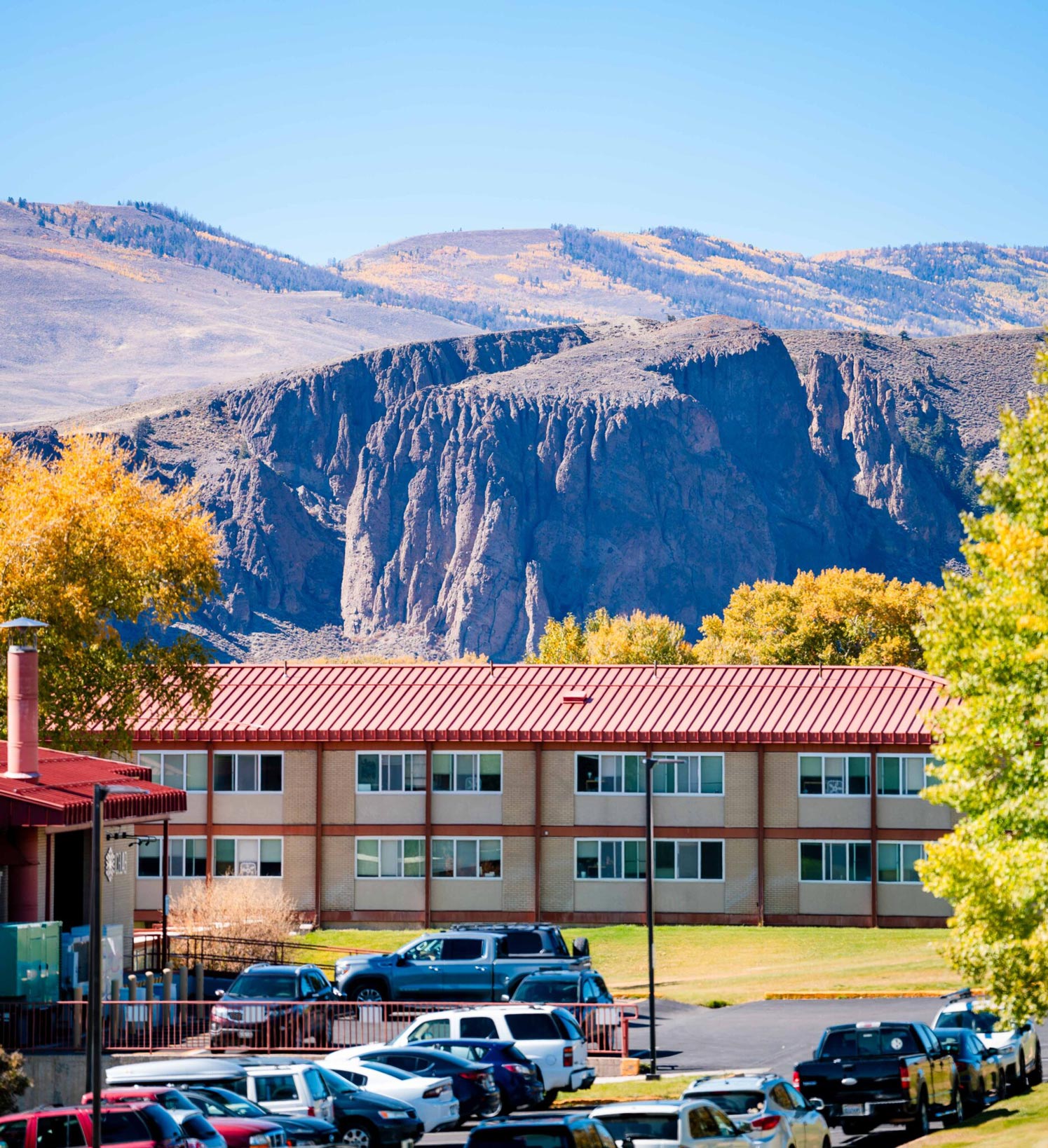 Exterior of the Escalante Complex on a blue sky day with the Palisades in the background.