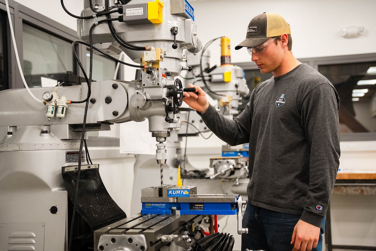 Individual drilling a new piece of his project